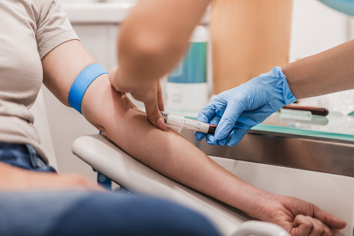 Clinician taking a blood sample from an athlete